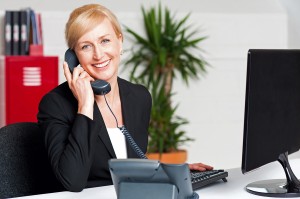 Secretary Talking On Phone With Client