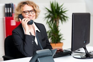 Happy Front Desk Lady Attending Clients Call