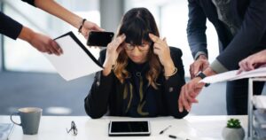 Woman overwhelmed at work desk